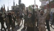 FILE PHOTO: Members of al Qaeda's Nusra Front gesture as they cheer in the northwestern city of Ariha, after a coalition of insurgent groups seized the area in Idlib province May 29, 2015. REUTERS/Khalil Ashawi
