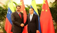 Venezuela's President Nicolas Maduro and Chinese Premier Li Keqiang shake hands during their meeting in Beijing, China September 14, 2018. Miraflores Palace/Handout via REUTERS 