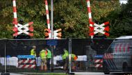 Rescue personnel work at the scene where a train struck a 