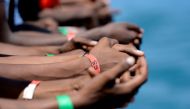 FILE PHOTO: Hands of migrants are seen on board the MV Aquarius in the harbour of Valletta, Malta, August 15, 2018. REUTERS/Guglielmo Mangiapane/File Photo
 