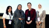 Sheikha Asma Al Thani (second left), Director of Marketing and Communications at Qatar Olympic Committee and the keynote speaker at Doha Women Forum 2018, receives an award from Julie Amey (second right), Vice-President of Finance at Qatar Shell, at the W