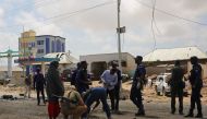 Somalian security officials investigate the scene after a suicide attack carried out with a bomb-laden vehicle during the passing of Italian military convoy on October 01, 2018 in Mogadishu, Somalia. Sadak Mohamed - Anadolu