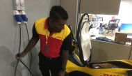 Benjamin Jacob, a delivery driver for DHL eCommerce, tests his electric scooter at a depot on the outskirts of Kuala Lumpur, Malaysia, September 20, 2018. Thomson Reuters Foundation/Michael Taylor