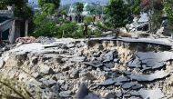 A survivor looks at damage to his neighbourhood in Palu, Indonesia's Central Sulawesi on October 2, 2018, after an earthquake and tsunami hit the area on September 28. / AFP / Jewel SAMAD 