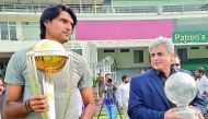 Pakistan pacer Muhammad Irfan (left) holds the World Cup 2019 trophy as it arrived in Lahore, while former Pakistan cricketer and PCB’s Director International Cricket Zakir holds the 1992 World Cup trophy which was also put on display at Gaddafi Stadium  