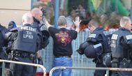 A reveller is checked by police on his arrival for a neo-nazi rock concert in Apolda, eastern Germany on October 6, 2018. Germany OUT / AFP / dpa / Sebastian Haak 