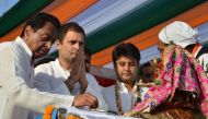 India Congress Party President Rahul Gandhi (2L) with Senior Congress leader Kamal Nath (L) offer prayers at the bank of the river Narmada in Jabalpur. AFP