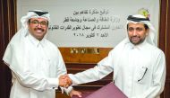 H E Dr Mohammed bin Saleh Al Sada (left), Minister of Energy and Industry, shakes hand with Dr Hassan bin Rashid Al Derham, Qatar University President, after signing the MoU yesterday. 