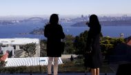 File photo: The Sydney Opera House and Harbour Bridge can be seen behind real estate agent and a potential buyer from Shanghai, during an inspection of a property for sale in the Sydney suburb of Vaucluse, Australia, July 11, 2015. Reuters/David Gray/File