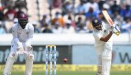 Indian cricketer Prithvi Shaw (R) plays a shot during the second day's play of the second Test cricket match between India and West Indies at the Rajiv Gandhi International Cricket Stadium in Hyderabad on October 13, 2018. GETTYOUT / AFP / NOAH SEELAM 