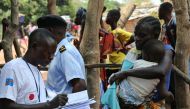 An official from the International Organization for Migration (IOM) collects data and registers a Congolese migrant who crossed from Angola at the Kamako border, Kasai province in the Democratic Republic of the Congo, October 13, 2018. Picture taken Octob