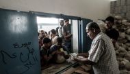 REPRESENTATIVE IMAGE: Palestinians receive aids at a United Nations food distribution centre in Jabalia refugee camp in the northern Gaza Strip, on August 8, 2018. (AFP/ Mahmud Hams)