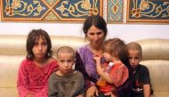 A handout picture released by the official Syrian Arab News Agency (SANA) on October 20, 2018 shows a woman and four children among the six released of 27 Druze hostages held by the Islamic State (IS) group in a prisoner swap and ransom, upon their arriva