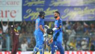 Indian batsman and team captain Virat Kohli (R) celebrates with his teammate Rohit Sharma after completing his century (100 runs) during the first one day international (ODI) cricket match between India and West Indies at Barsapara Cricket Stadium in Guwa