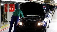 FILE PHOTO: A worker inspects cars at BMW's manufacturing plant in Rosslyn, outside Pretoria, September 13, 2010. REUTERS/Siphiwe Sibeko/File Photo