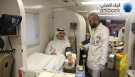 A young man donating blood during an Ahlibank blood donation campaign. 