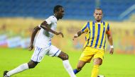 Al Gharafa’s Wesley Sneijder (right) vies for ball possession with an Al Khor player during their QNB Stars League match in Doha yesterday.