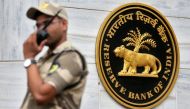 FILE PHOTO: A guard stands next to the Reserve Bank of India (RBI) logo outside its headquarters in Mumbai, India, October 5, 2018. REUTERS/Francis Mascarenhas/File Photo