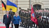 Ukrainian President Petro Poroshenko (L) and German Chancellor Angela Merkel speak as they walk in front of a guard of honour during a welcoming ceremony before their meeting in Kiev on November 1, 2018. / AFP / GENYA SAVILOV