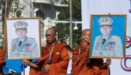 Monks hold portraits of Myanmar military commander-in-chief Senior General Min Aung Hlaing during a rally to show support to the Myanmar military in Yangon on October 14, 2018. (AFP/Ye Aung Thu) 