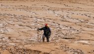 A civil defense member looks for missing persons after rain storms unleashed flash floods, in Madaba city, near Amman, Jordan, November 10, 2018. REUTERS/Muhammad Hamed