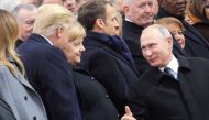 Russian President Vladimir Putin talks with German Chancellor Angela Merkel and U.S. President Donald Trump as they attend a commemoration ceremony for Armistice Day, 100 years after the end of the First World War at the Arc de Triomphe, in Paris, France,