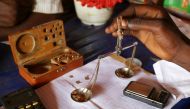FILE PHOTO: A trader weighs gold in his shop in Djoubissi, Central African Republic on April 24, 2014. Reuters/Emmanuel Braun