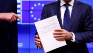 European Council President Donald Tusk poses with the Brexit draft text handed over by European Union's chief Brexit negotiator Michel Barnier in Brussels, Belgium, November 15, 2018. REUTERS/Francois Lenoir