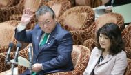 Yoshitaka Sakurada (L), 68, the deputy chief of the government's cyber security strategy office raising his hand to answer a question beside Satsuki Katayama (R), minister in charge of regional revitalisation and female empowerment, during a parliament se