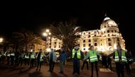 Protesters wearing yellow vests, a symbol of a French drivers' protest against higher fuel prices, attend a demonstration in front of the Negresco Hotel ahead of a nationwide protest, in Nice, France, November 15, 2018. REUTERS/Eric Gaillard