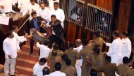 Parliament member Johnston Fernando who is backing newly appointed Prime Minister Mahinda Rajapaksa throws a chair at police who are there to protect parliament speaker Karu Jayasuriya (not pictured) during a parliament session in Colombo, Sri Lanka Novem
