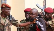 Members of the armed forces arrest on October 29, 2018 Central African MP Alfred Yekatom who represents the southern M'baiki district former militia leader, after he fired the gun at the parliament in Bangui.  AFP / Gael Grilhot 