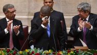 Angolan president Joao Lourenco Angolan president Joao Lourenco (C) wipes his face after delivering a speech at the parliament in Lisbon on November 22, 2018. AFP / Francisco Leong  