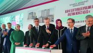 President Recep Tayyip Erdogan (4th R) presses a button during the opening ceremony of the Istanbul Medeniyet University Science and Advanced Technology Application and Research Center and also groundbreaking ceremony of the Ziraat Bank Library in Istanbu