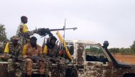 FILE PHOTO:  In this file photo taken on July 18, 2011 Malian troops patrol on a pick-up car, three weeks after a military raid dislodged Al-Qaeda in the Islamic Maghrab (AQIM) from its newly-built base in the Wagoudou forest.  AFP / SERGE DANIEL