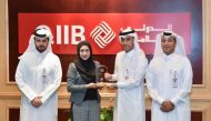 Jamal Abdullah Al Jamal (second right), QIIB Deputy CEO, receiving the award from Dr. Sofiza Azmi.