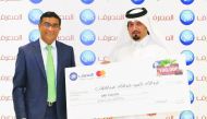 Abdullah Al Sayed (right) receiving the cash prize from QIB’s General Manager-Personal Banking Group, D. Anand.