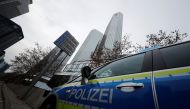 :Police vehicles are parked in front of Deutsche Bank headquarters as roughly 170 criminal police officers, prosecutors and tax inspectors searched Deutsche Bank offices in and around Frankfurt, Germany, November 29, 2018, on money laundering allegations,