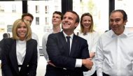 France's President Emmanuel Macron and his wife Brigitte speak with French entrepreneur and businessman Xavier Niel (R) during the inauguration of start-ups incubator 
