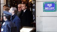 French President Emmanuel Macron (L) looks on at Cafe Belloy, near the Arc de Triomphe in Paris on December 2, 2018, a day after clashes during a protest of Yellow vests (Gilets jaunes) against rising oil prices and living costs.   AFP / Geoffroy VAN DER 