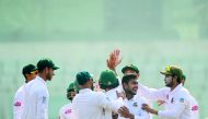 Bangladesh cricketer Shakib Al Hasan (R) congratulate teamamte Mehidy Hasan (2nd R) after the dismissal of the West Indies cricketer Devendra Bishoo during the third day of the second Test cricket match between Bangladesh and West Indies at the Sher-e-Ban