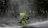 Anti-riot police use a water cannon during clashes with 