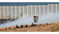 Israeli forces intervene protesters with gas bombs as Palestinians gather to support the 18th 'maritime demonstration' to break the Gaza blockade by sea with vessel near the north coast border in Gaza City, Gaza on December 3, 2018. (Ali Jadallah/Anadolu 