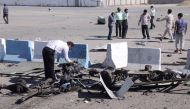 A policeman inspects the wreckage of a car bomb which exploded in front of a police station in the city of Chabahar, on December 06, 2018 in southern Iran. AFP / FARS NEWS AGENCY
