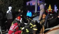 This handout picture taken and released by Vigili del Fuoco, the Italian fire and rescue service, on December 8, 2018, shows emergency personnel treating victims after a stampede at a nightclub in Cornaldo. AFP PHOTO /VIGILI DEL FUOCO