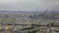 Black smoke rises above Paris buildings on December 8, 2018 during a protest of the 