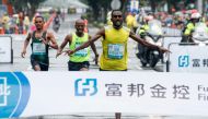 Kenya's Aredom Tiumay Degefa celebrates before crossing the finish line to win the men's race of the Taipei marathon on December 9, 2018. AFP / HSU Tsun-hsu