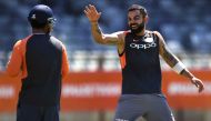 India's cricket captain Virat Kohli (R) shares a lighter moment with teammate Rishabh Pant (L) during a training session in Perth on December 12, 2018. AFP / William West 
