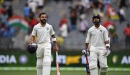 India's batsmen Ajinkya Rahane (R) and Virat Kohli walk back to the dressing room at the end of day two of the second Test cricket match between Australia and India in Perth on December 15, 2018.(AFP / WILLIAM WEST)