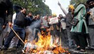 People burn placards and effigies of India's main opposition Congress party's leaders Sajjan Kumar and Kamal Nath during a protest near Congress party's headquarters in New Delhi, India, December 17, 2018. REUTERS/Anushree Fadnavis